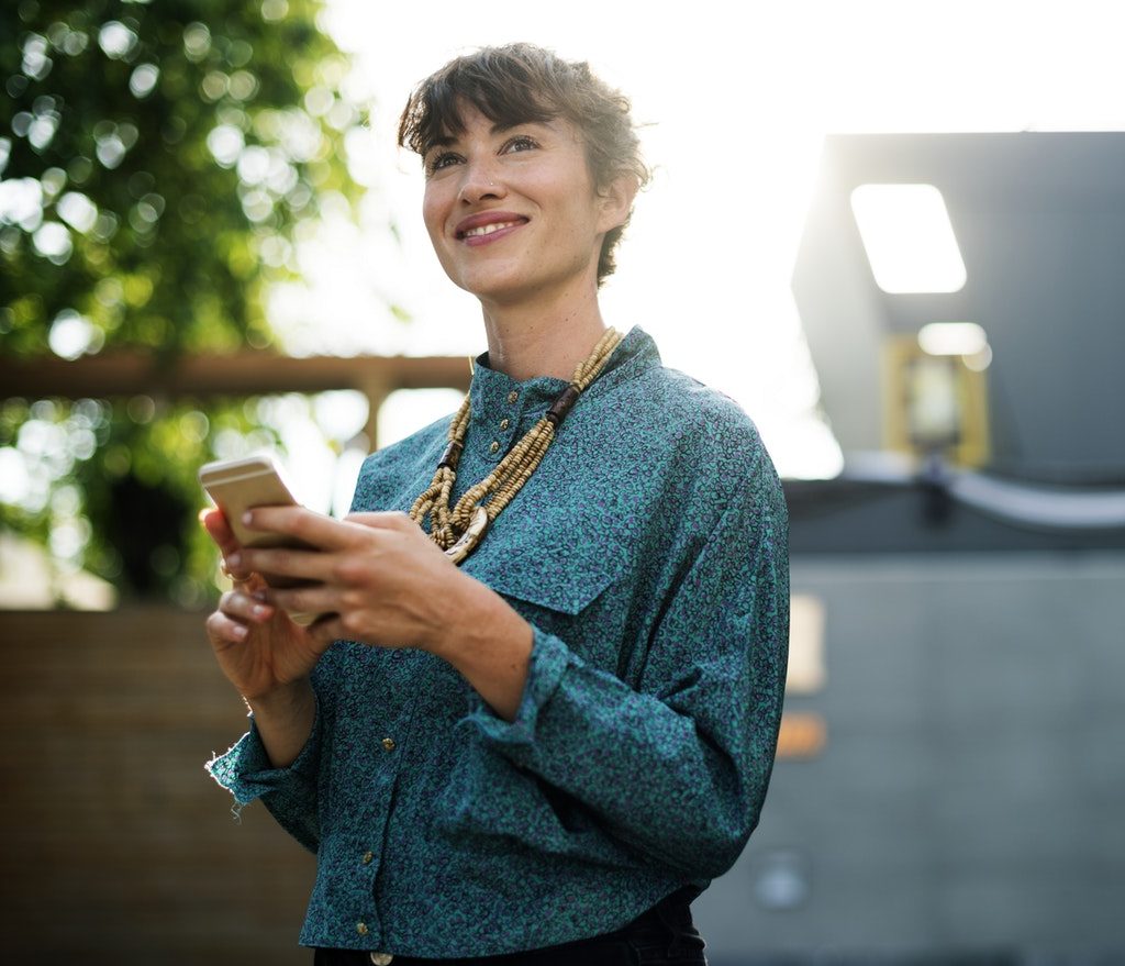 Employees checks her smartphone