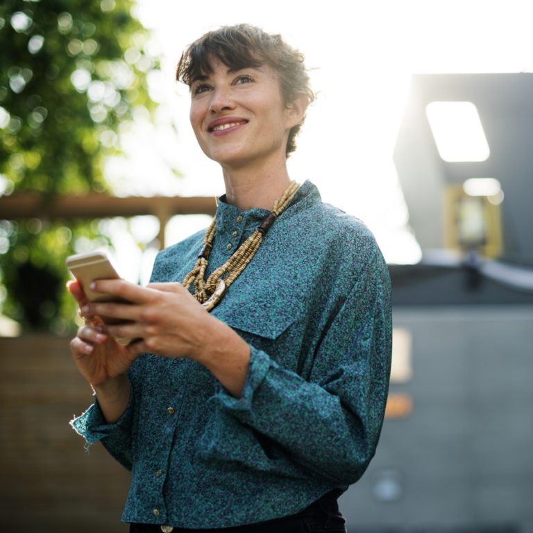 Employees checks her smartphone