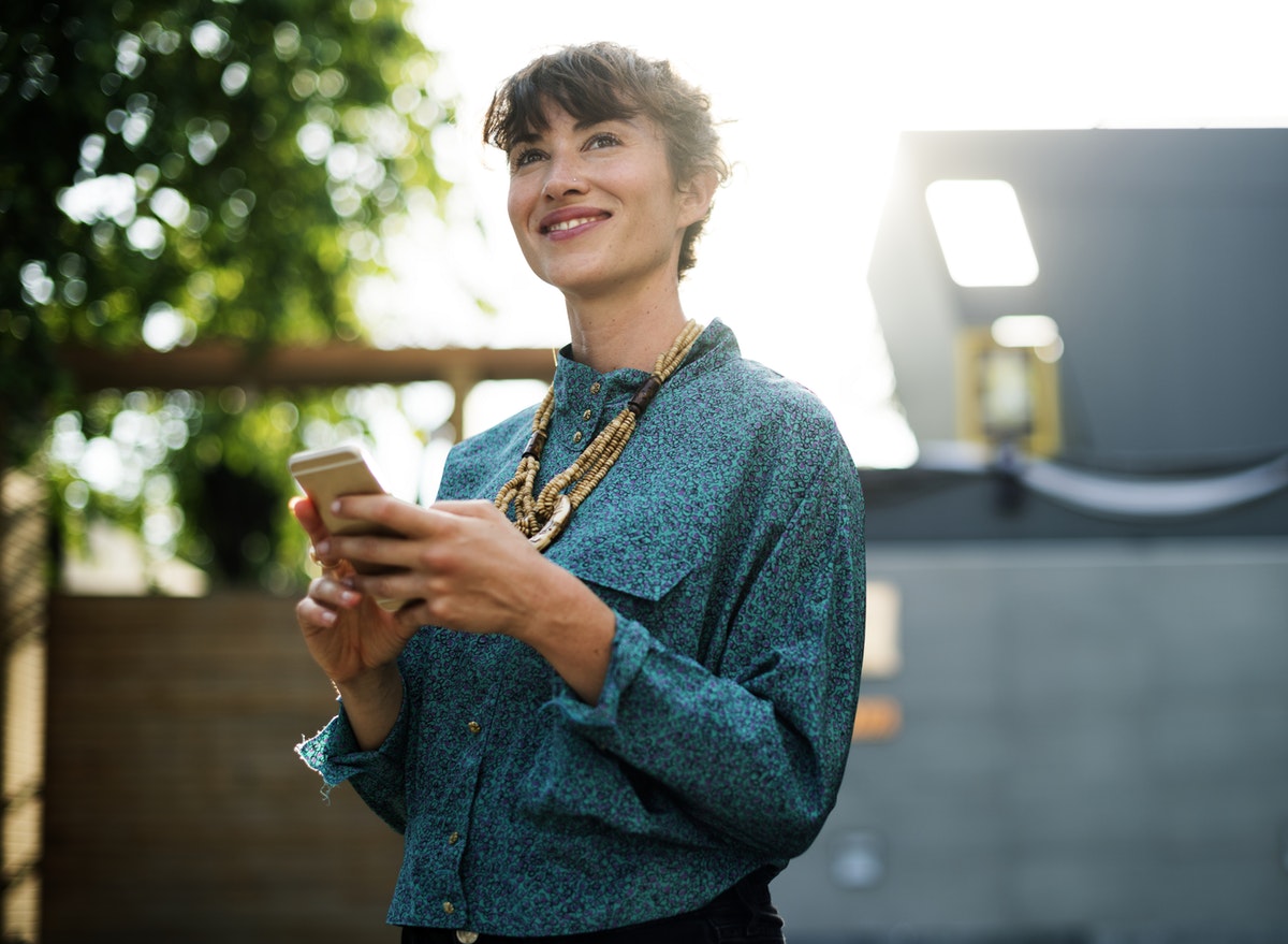 Employees checks her smartphone